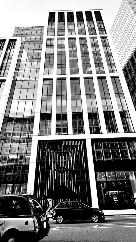 Black and white picture of IBM building in London. Interconnection between vertical and horizontal lines