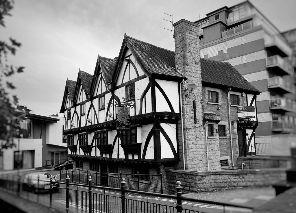 Picture of an old pub surrounded by modern buildings