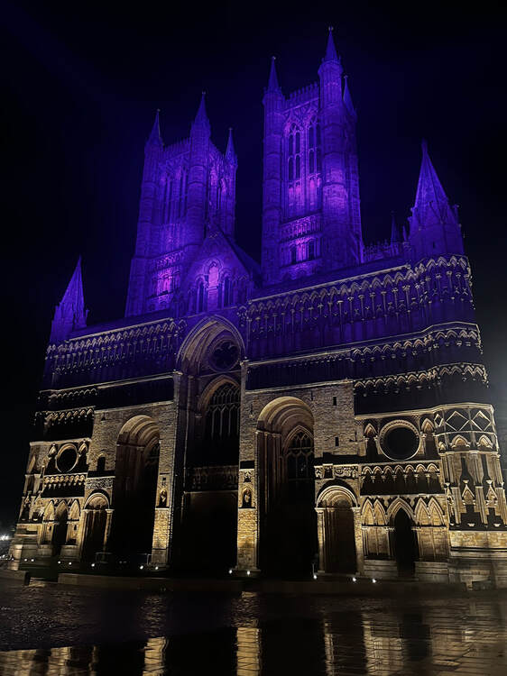 Lincoln Cathedral with the top stores illuminated in purple